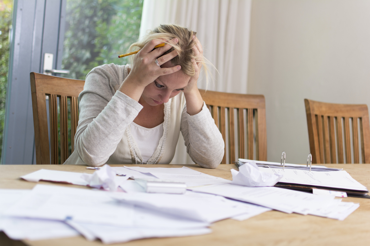 Upset woman with paperwork
