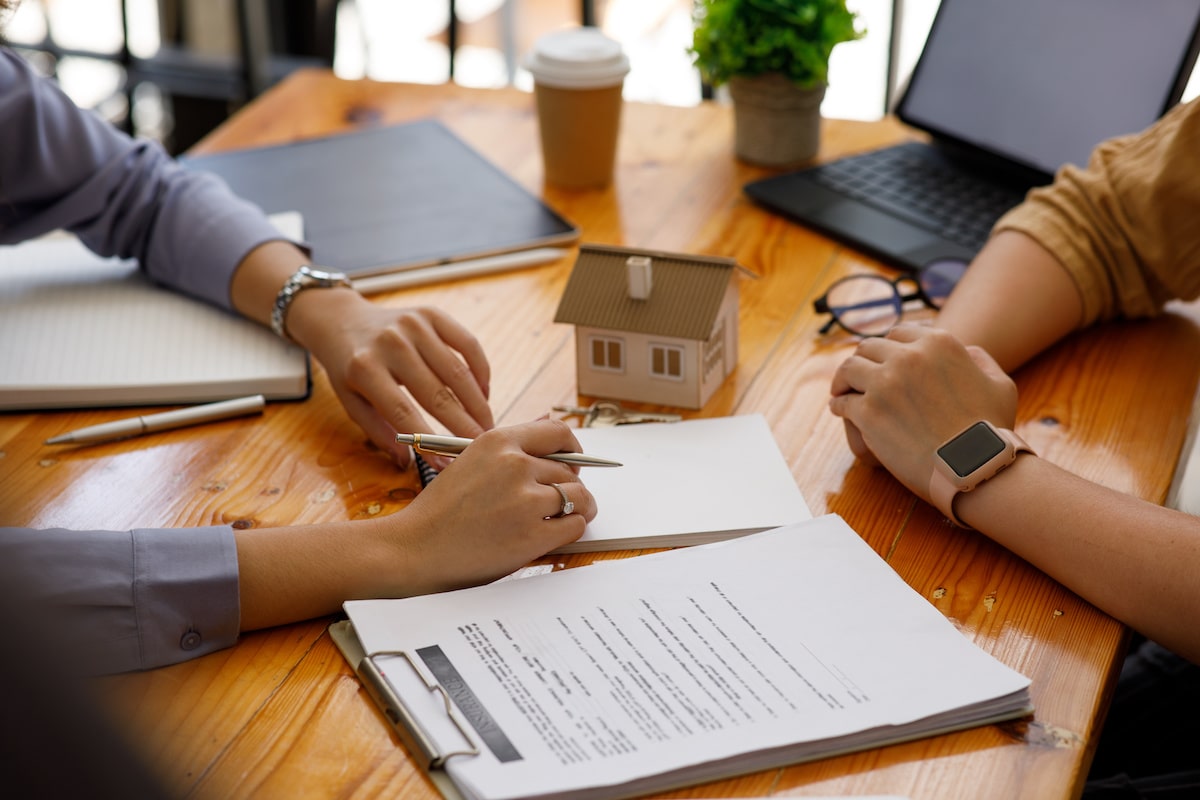 Real estate meeting with buyer signing papers
