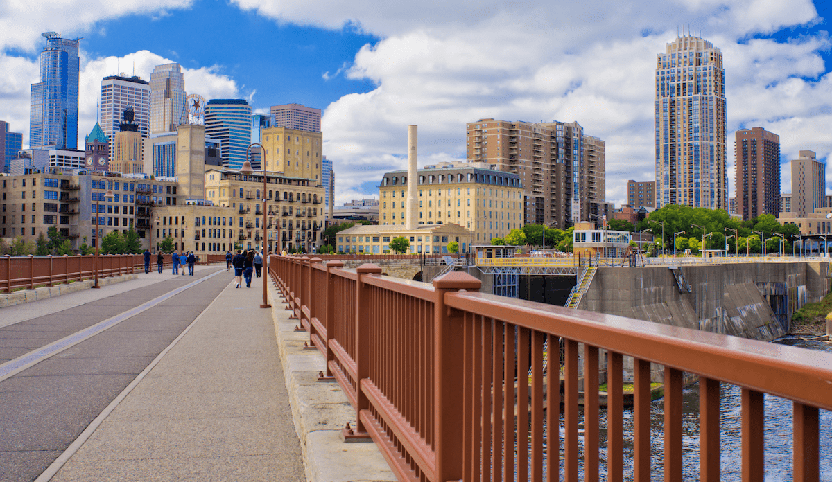 View of Minneapolis skyline with pedestrians on bridge