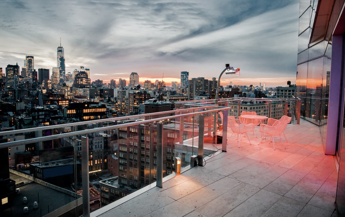View of New York City at dusk from a penthouse balcony