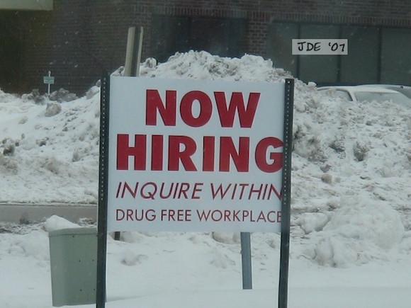 "Now hiring" sign to attract new employees.