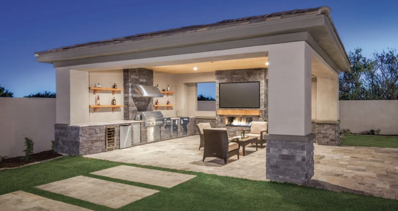 Popular features in home design include outdoor kitchens, like this one with a grill, fireplace, and comfortable seating