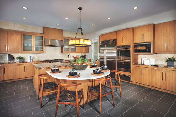 The warm wood cabinets and slate-gray flooring in this kitchen at Truewind, in Huntington Beach, Calif., by TRI Pointe Homes, is a recent example of the transitional look.