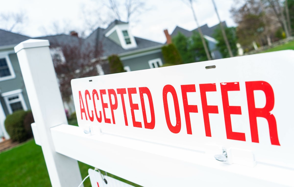 Accepted offer sign outside of for-sale house