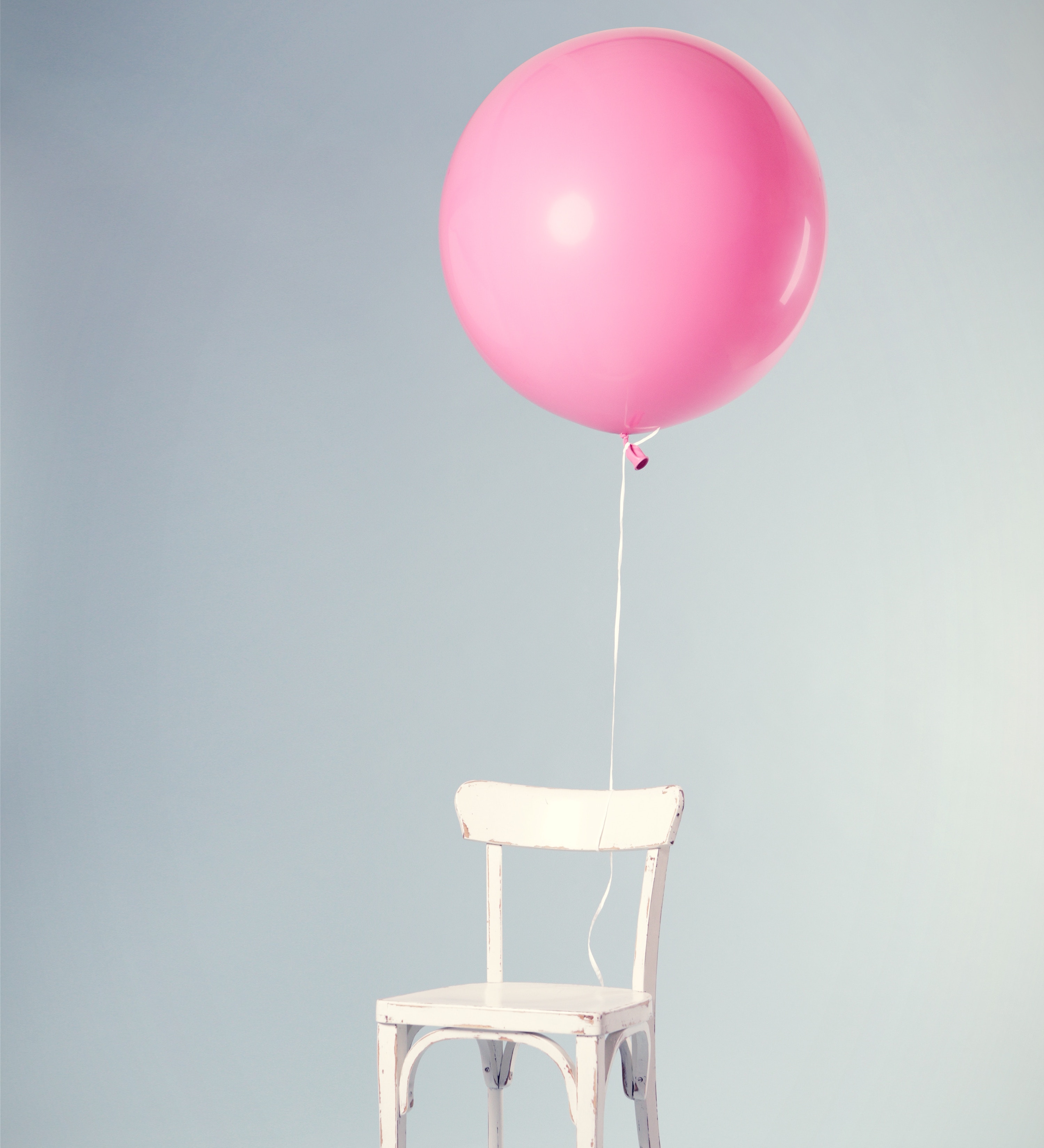 Chair with pink balloon tied on