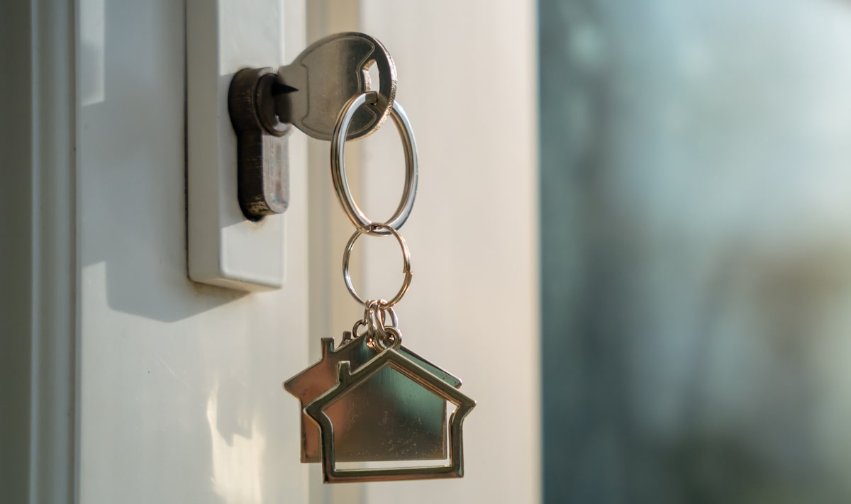 House key dangling from front door lock