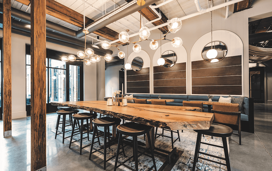 Interior, with salvaged wood tables, in the Chronicle Mill adaptive reuse project and 2023 BALA winner