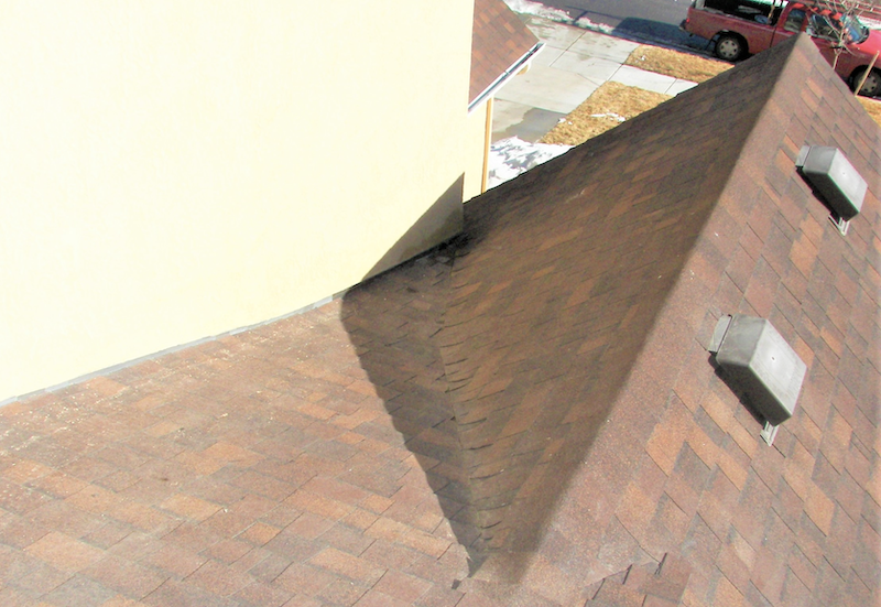 this roof plane/wall intersection detail will result in water intrusion and leaks