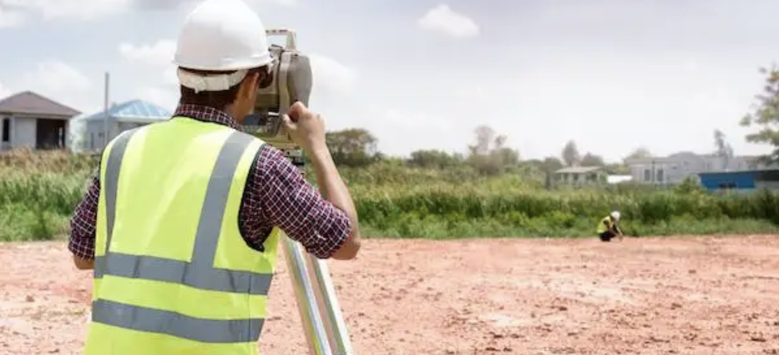 Surveyor surveying land for home builder acquisition and development