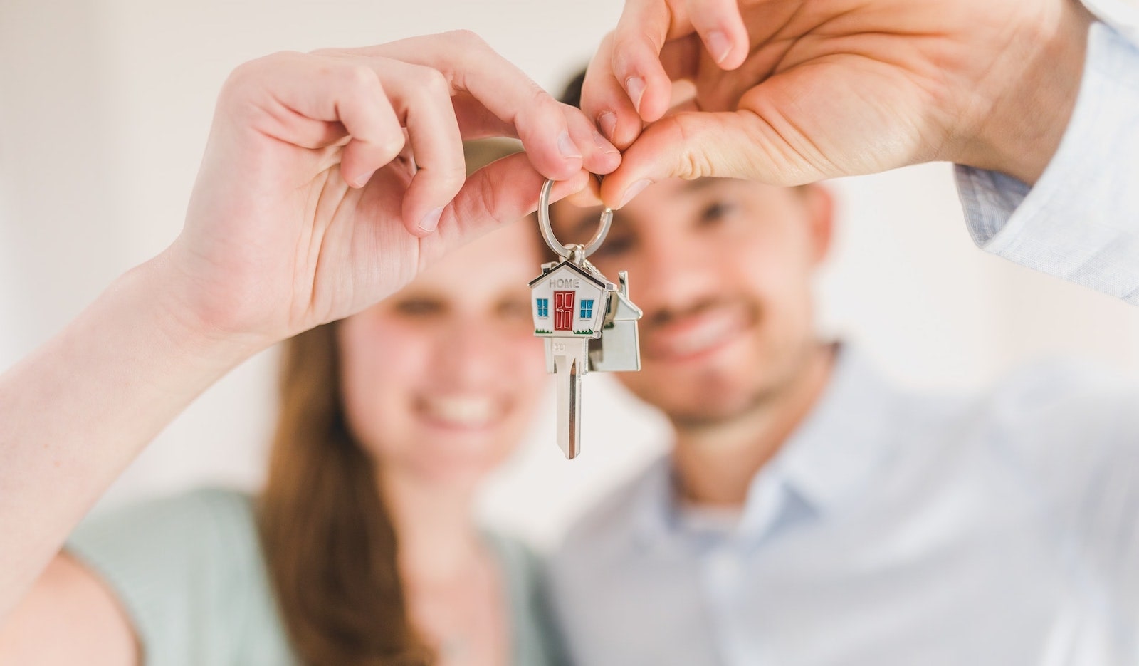 Millennial homebuyers with house keys in hand