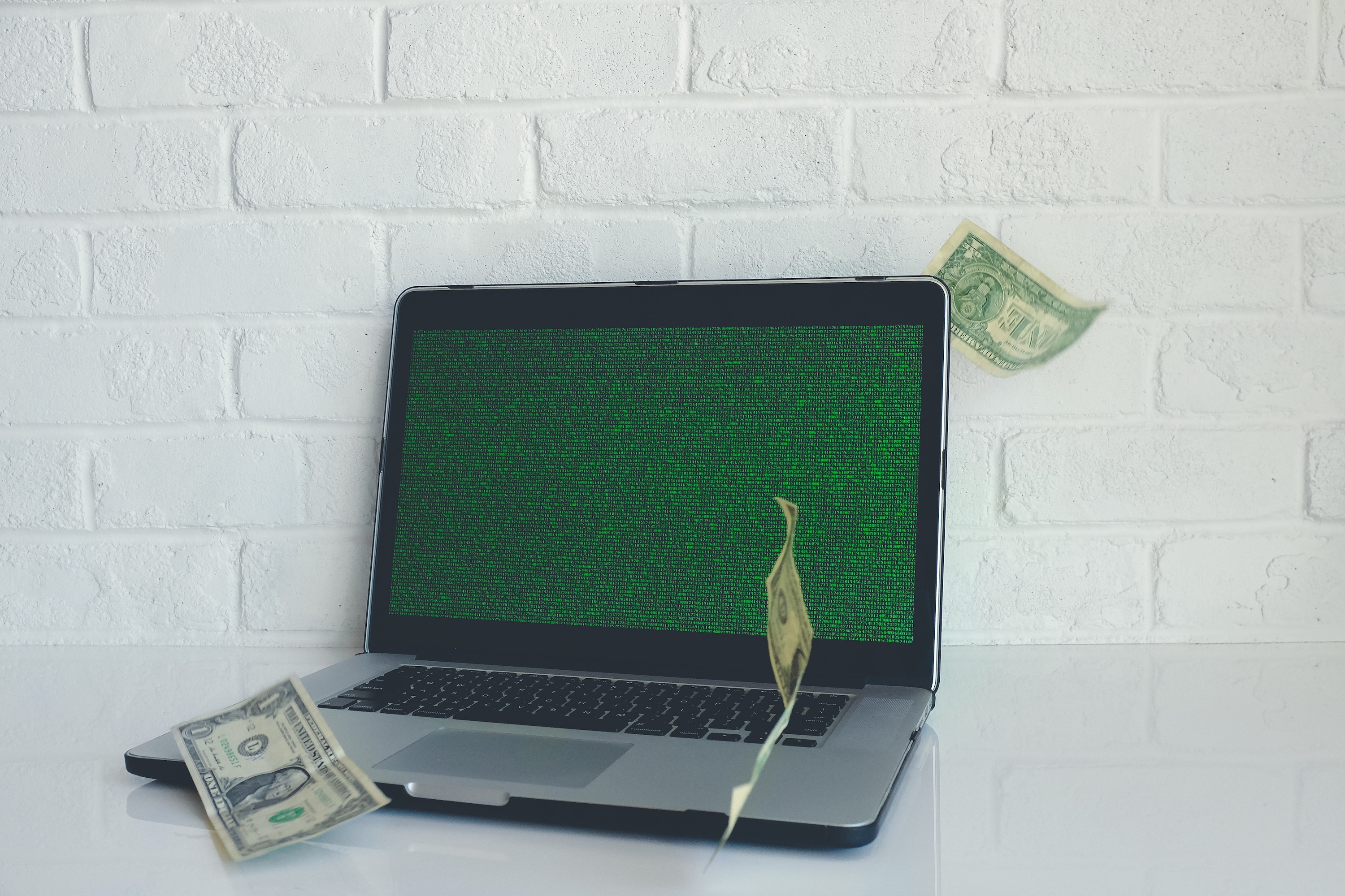 Laptop computer with dollar bills