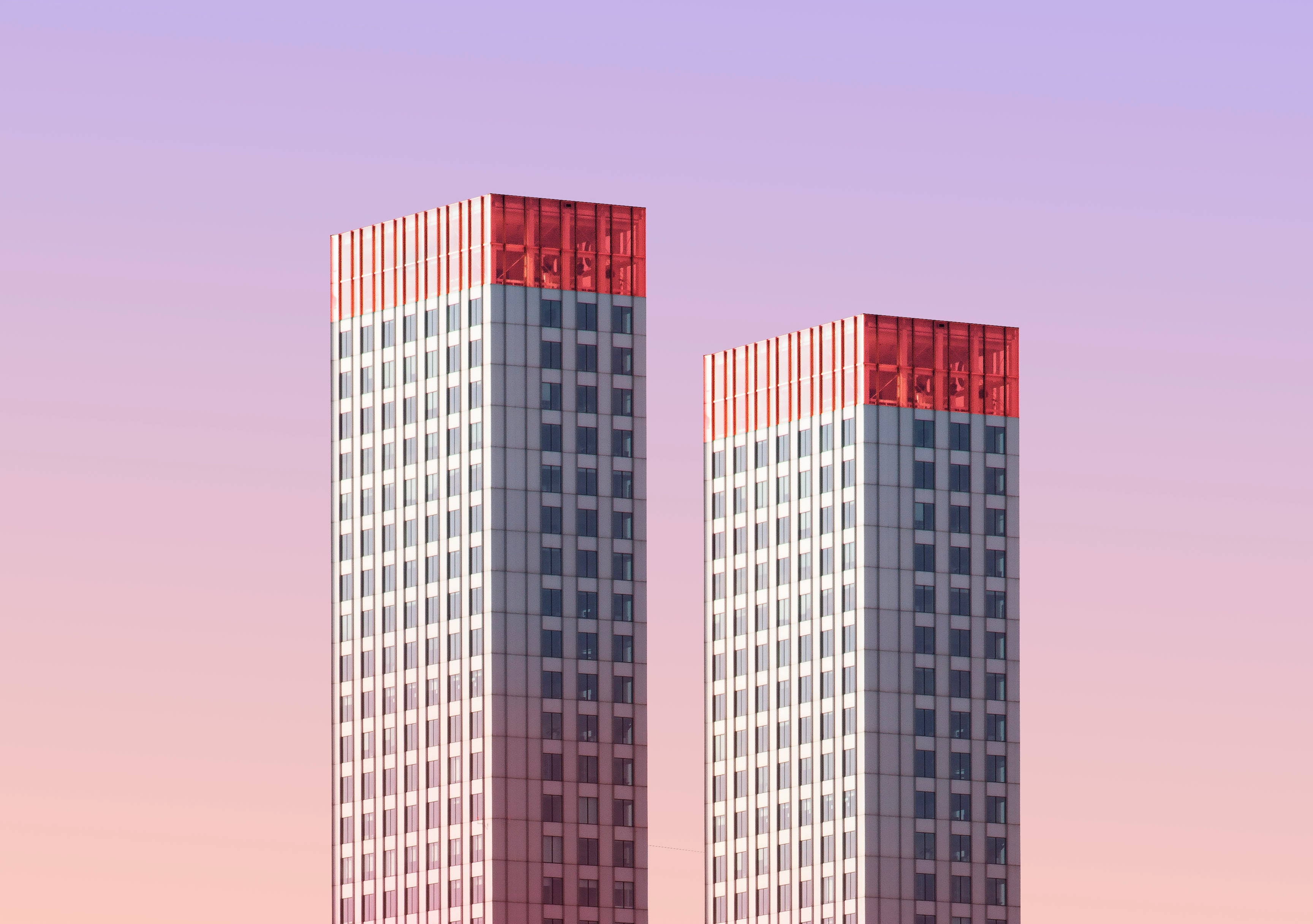 Two skyscrapers against a purple sky