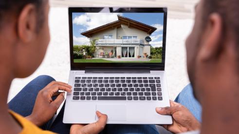 Couple looking at a house on laptop