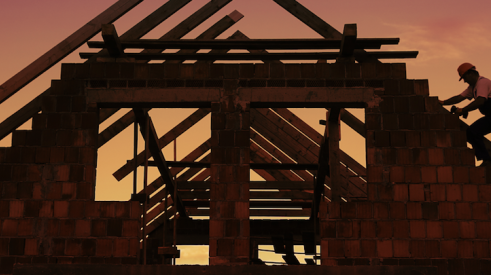 Carpenters frame roof of house at dusk