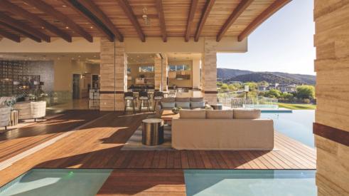An outdoor living space by Sun West Custom Homes that includes transition zones and water elements