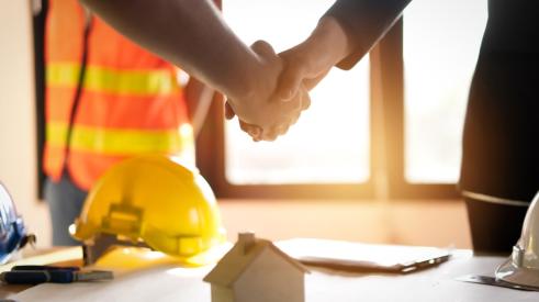 Builder and client shaking hands