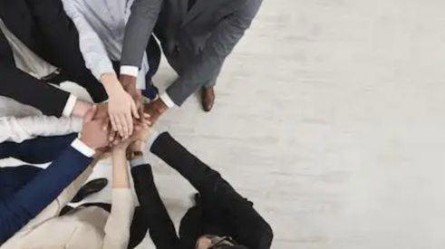 people with hands in circle show corporate diversity and teamwork 