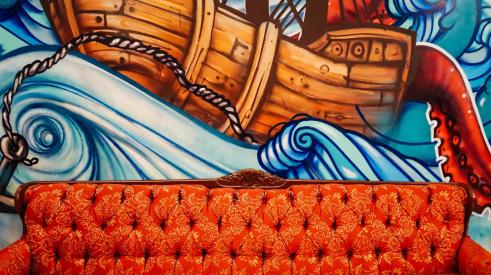 Sofa in front of mural