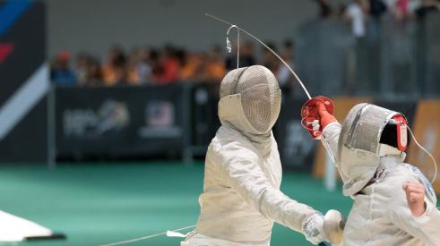 Two people fencing