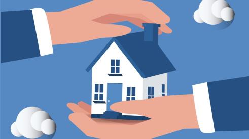 Hands holding house against blue background