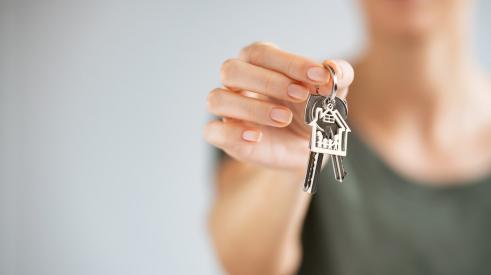 Person holding silver house keys