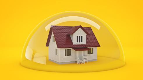 House trapped in bubble with yellow background