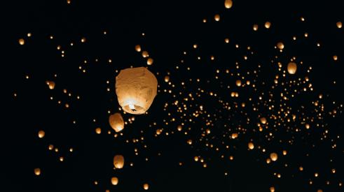 Candle lanterns in night sky