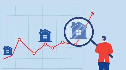 Person holding magnifying glass up to line graph with houses