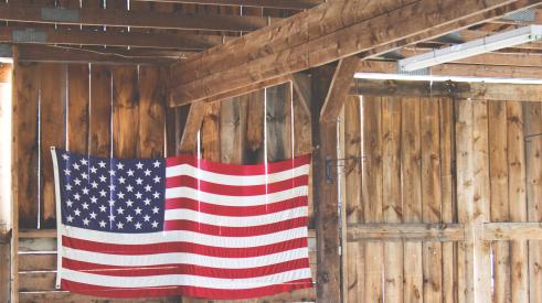 US Flag hanging inside of wooden structure