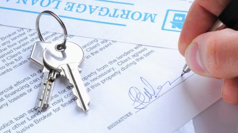 Mortgage loan paperwork with house keys