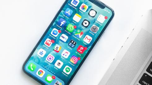 iPhone with apps on screen