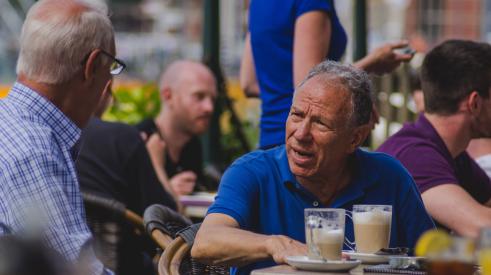 Two seniors sitting at a café