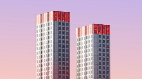 Two skyscrapers against a purple sky