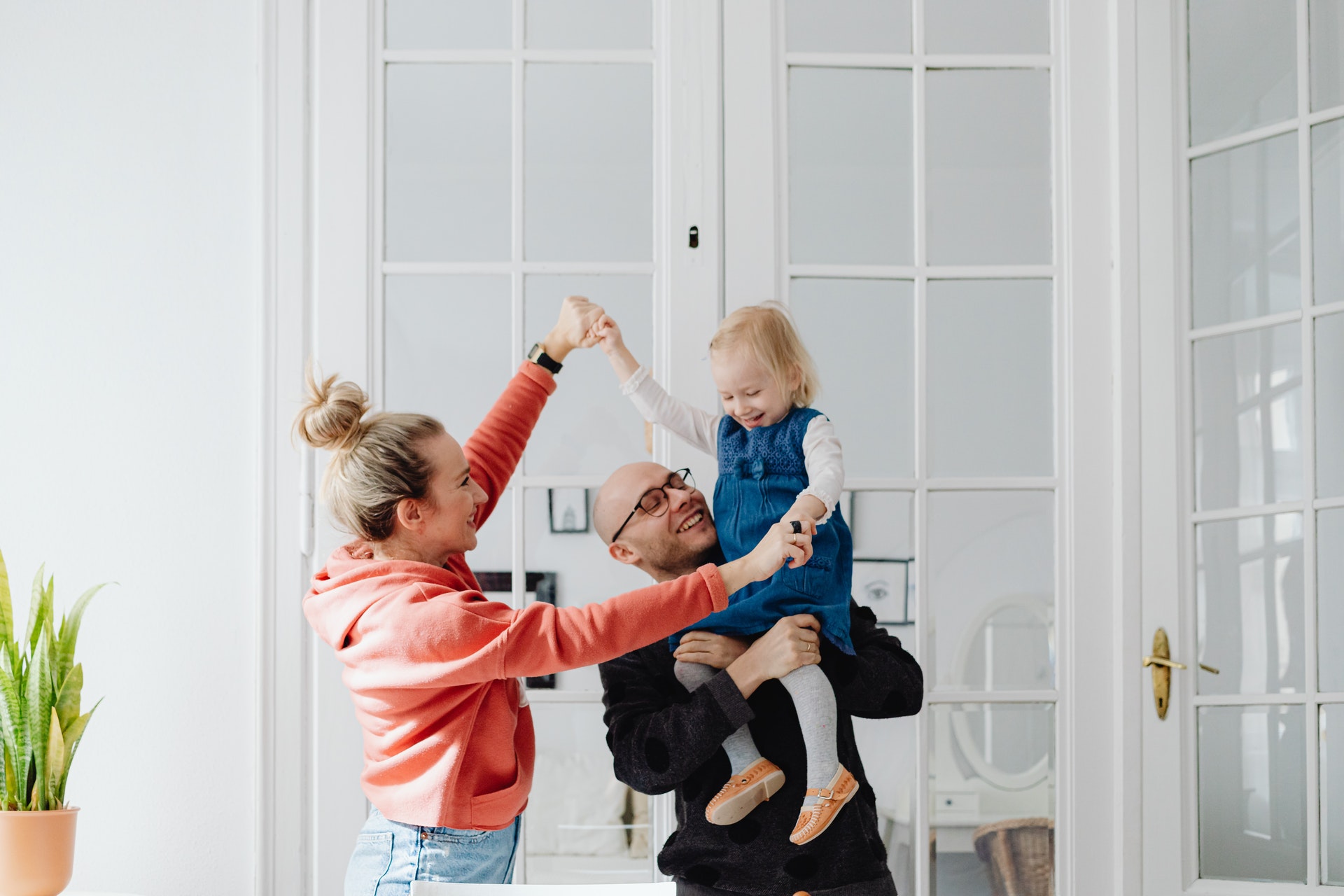 Couple with baby in clean house