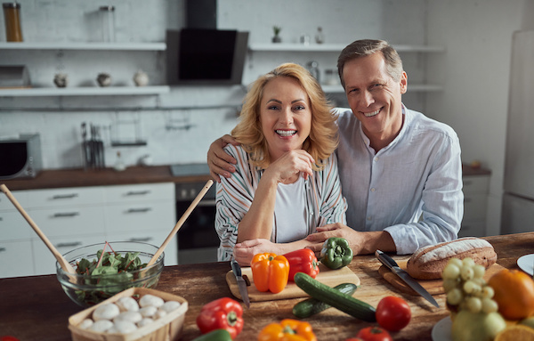 55 year old couple happy in the kitchen