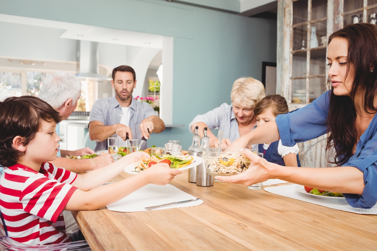 Multigenerational household eating a meal together