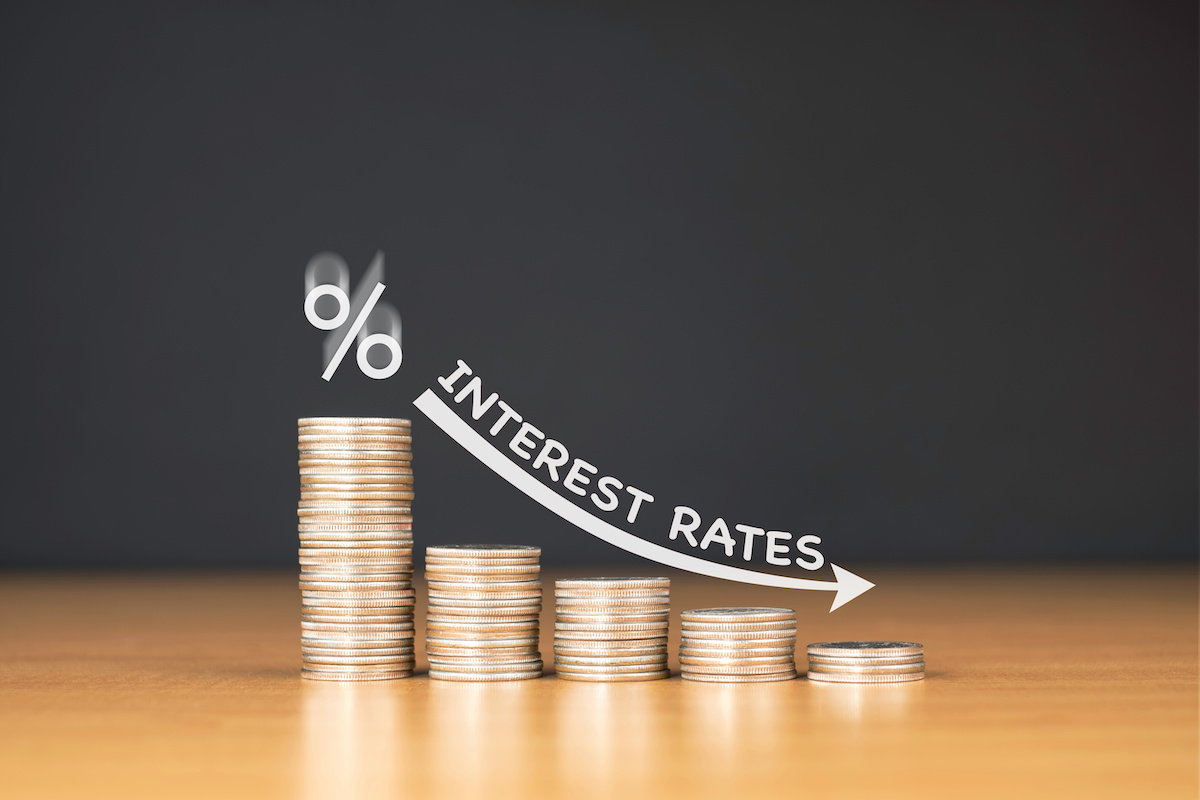 Coins decrease in size with an arrow. Above that are the words 'Interest rates.'