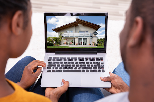 Couple looking at a house on laptop
