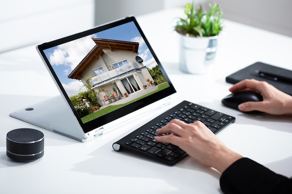 Person viewing an online listing of a home for sale