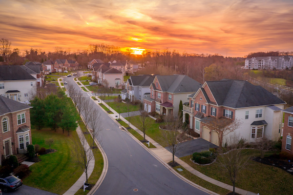 Suburban street with houses during sunset