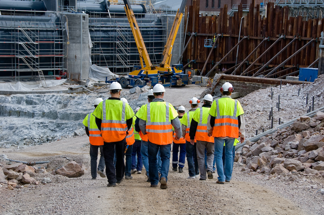 Group of construction workers walking to building site
