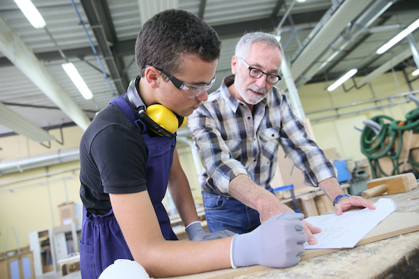 Student being taught construction trades in workshop