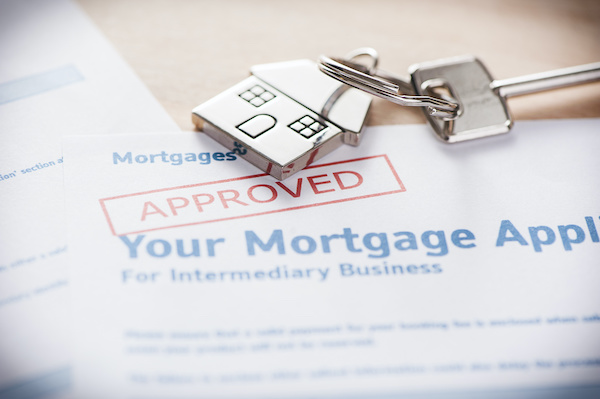 Approved mortgage application with house keys