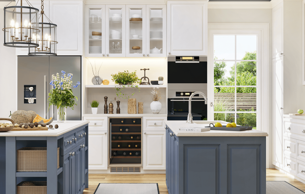 Blue and white kitchen with large windows for lots of natural light