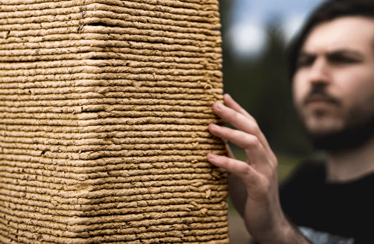 DART researchers next to tower constructed using biodegradable sawdust material