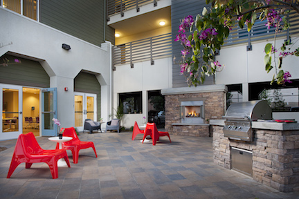 Courtyard with fireplace and grill at El Monte Veterans Village
