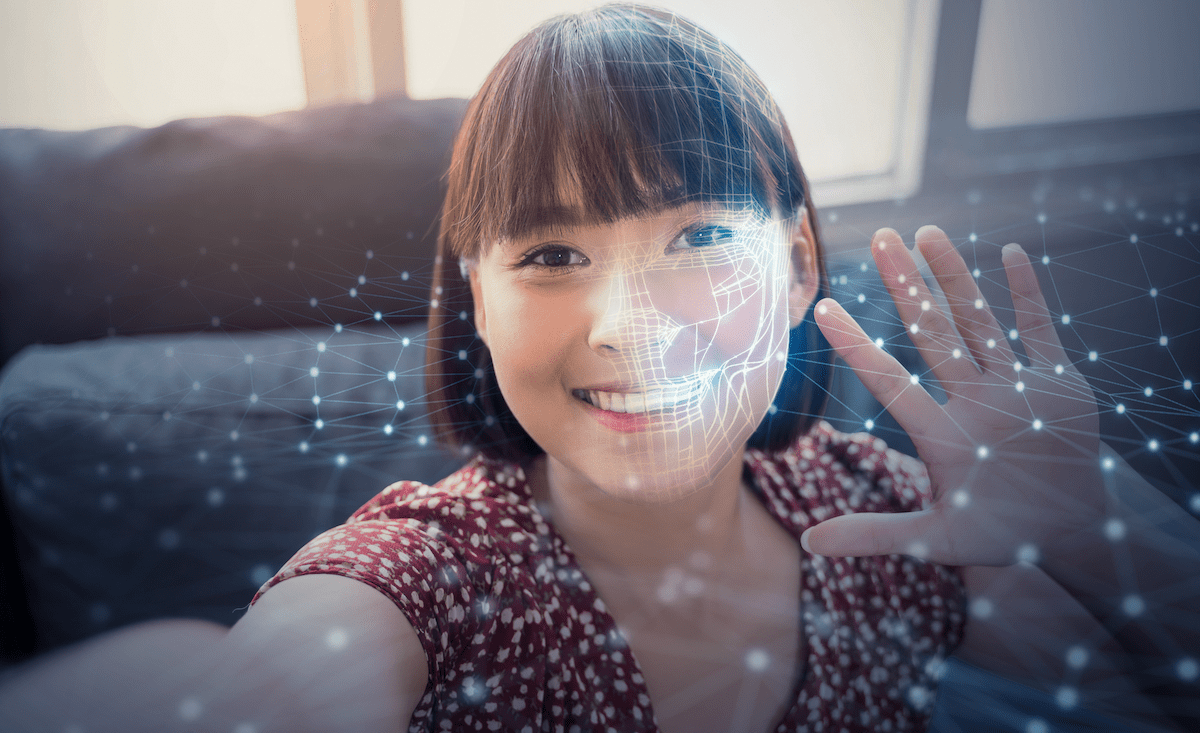 AI facial recognition for young woman raising her hand