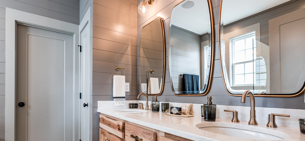 this master bath design from Garman Homes has accent tile and brass fixtures—two features homebuyers want today