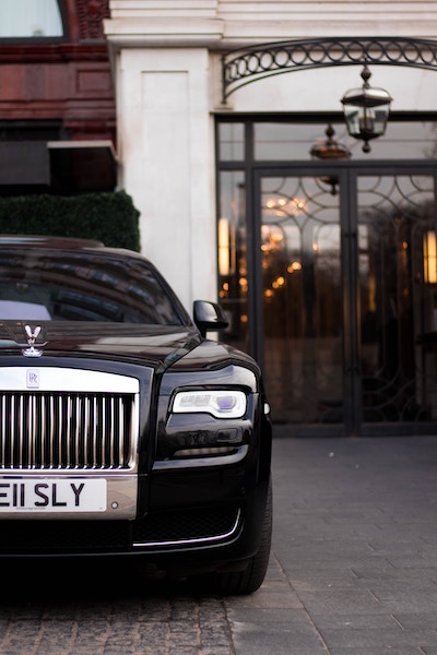 Luxury_car_parked_by_luxury_building