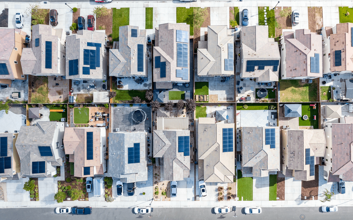 Aerial view of a row of single-family homes with solar panels on the roof